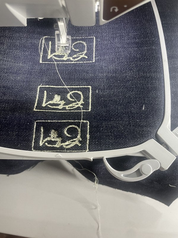Embroidery machine stitching Lolly J labels